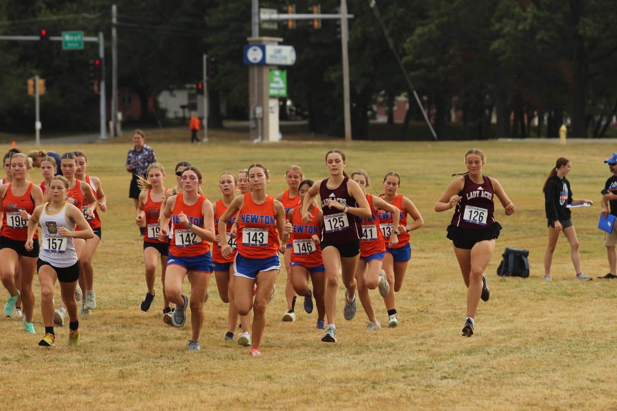 Olney, Newton, and Mt. Carmel runners soon after the start of the girls race at the Olney Invitational on Sept. 20th. Olney's Josie Ginder (196, far left) won the race (photo by The Hometown Register).