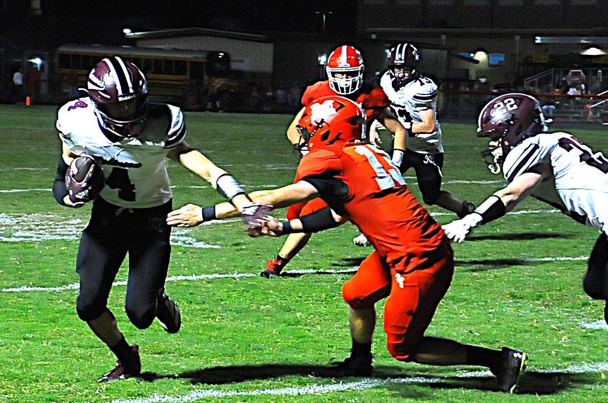 Robinson's Miles Hardiman goes outside to avoid a tackle against Marshall on Sept. 26 (Photo by Tom Lisella).