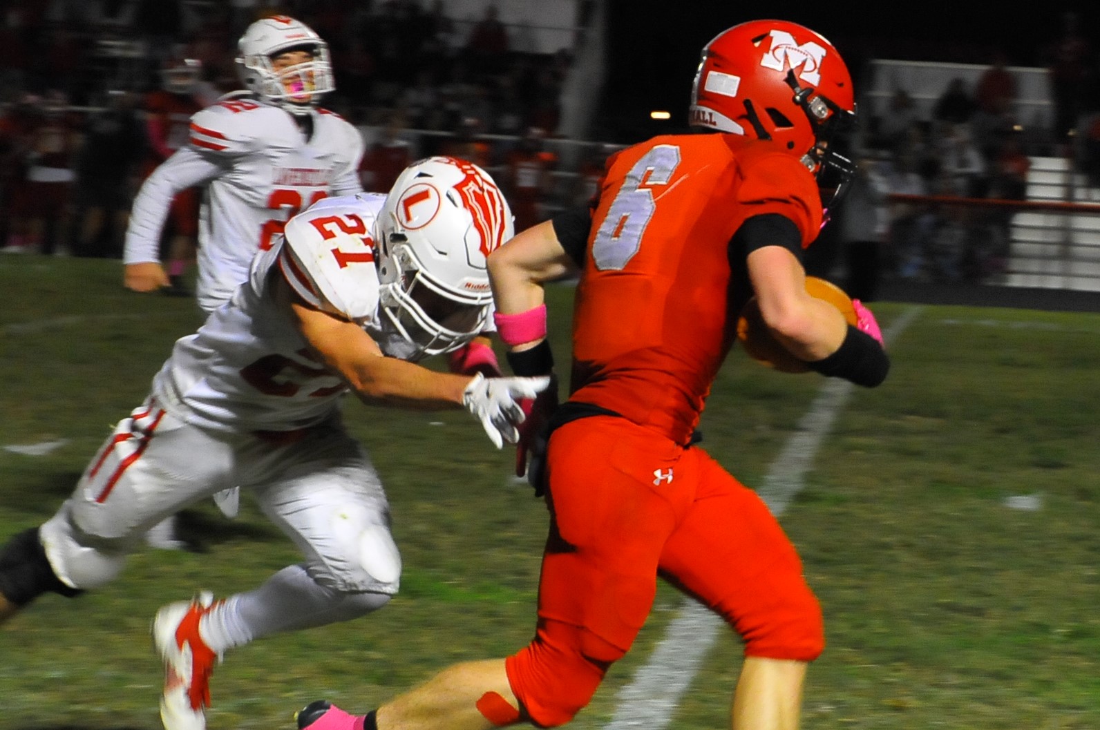 Marshall's Silas Dean (6) tries to shake off Lawrenceville's Zander Cessna during a game on Oct. 10 (Photo by Tom Lisella).