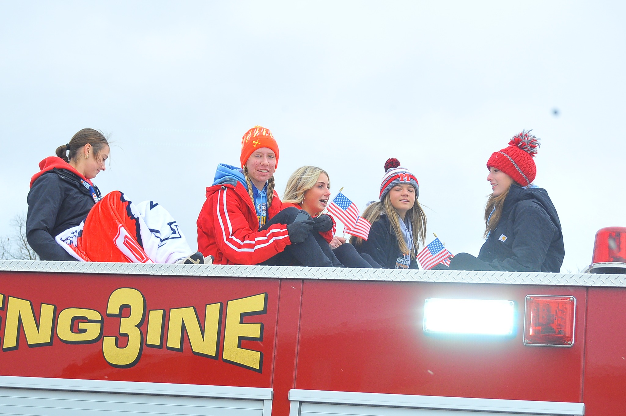 Marshall's cross country team rode atop a fire truck in the civic celebration that followed the Lions' 9th place finish at the IHSA state meet (Photo by Tom Lisella).