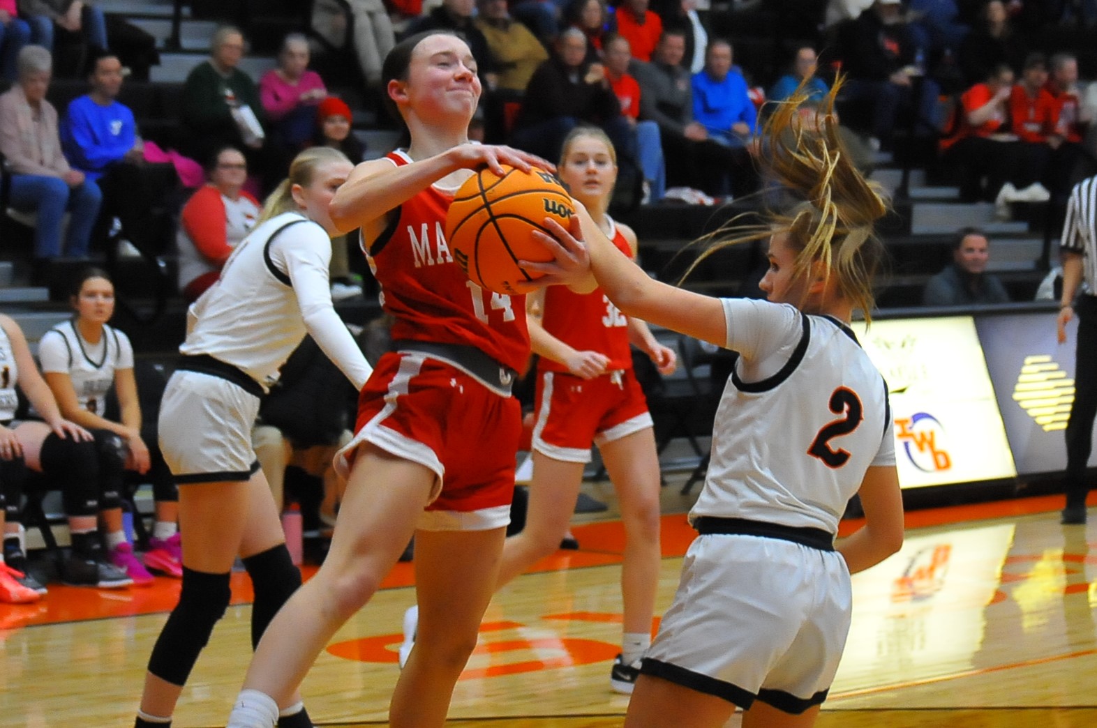 Marshall's Marlee Heighton (14) drives against Kilee Edwards of Paris in an LIC game at Paris on Dec. 8 (Photo by Tom Lisella).