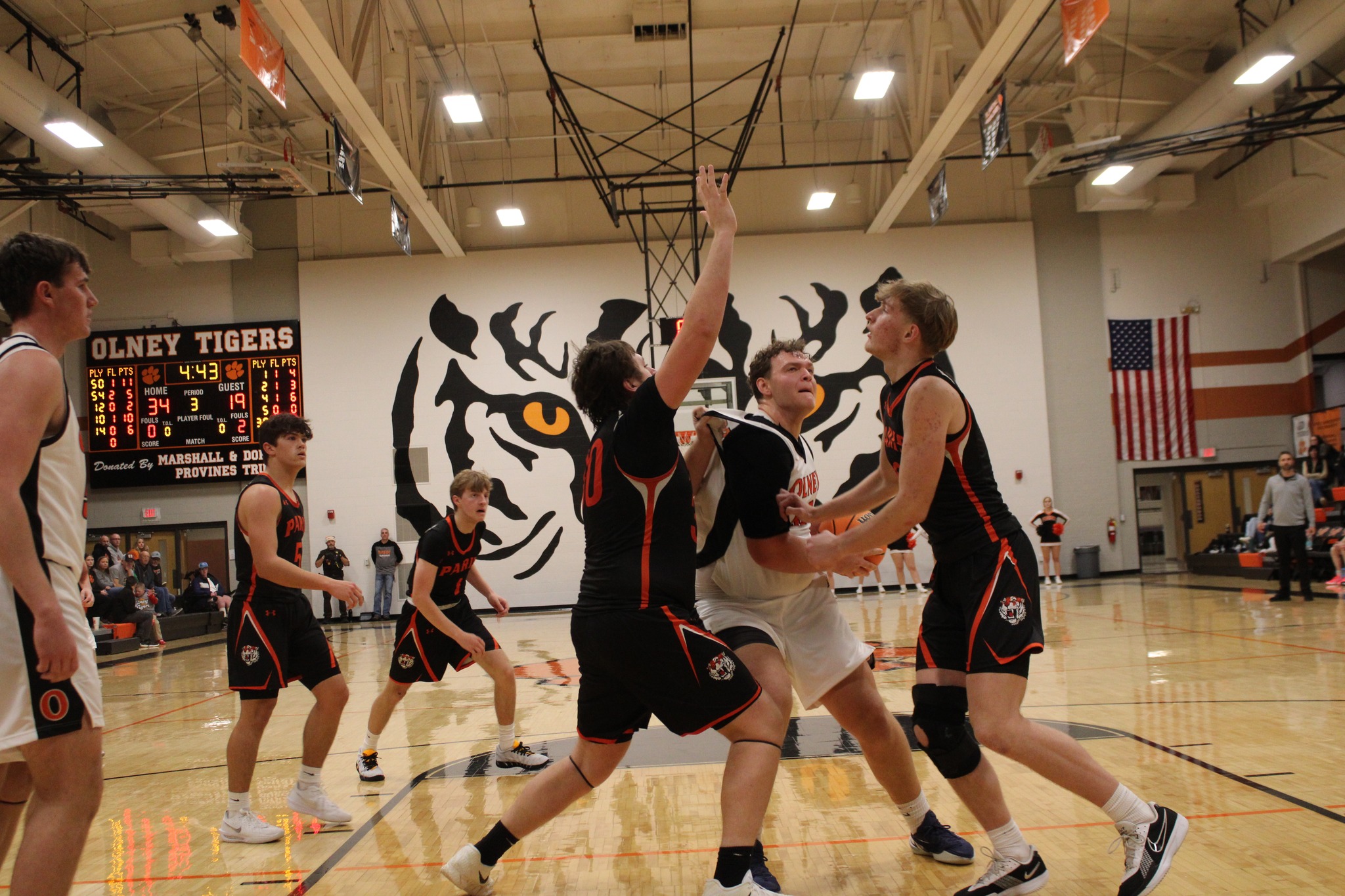 Casey Thomann of Olney goes inside against Paris to score his 1,000th career point (Photo by Justin Hatten).