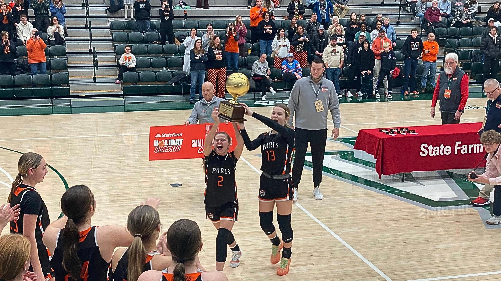 Kilee Edwards (2) and Kailey Young hoist the State Farm Classic championship trophy (Photo by Greston Miller).