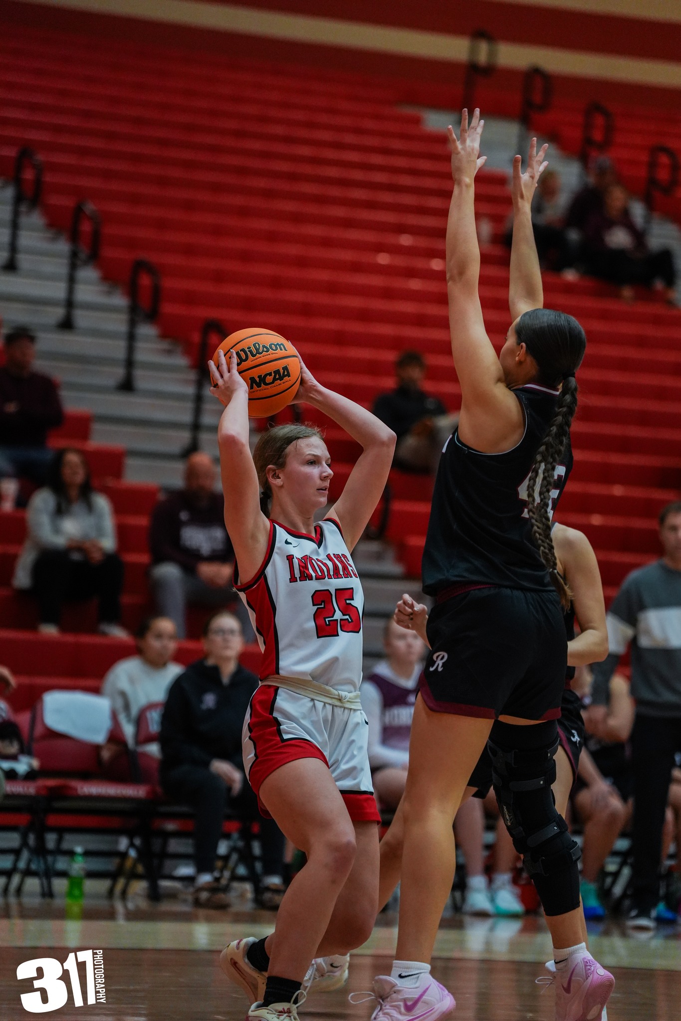 Lawrenceville's Brina Opat (25) looks to pass against defensive pressure from Lillie McDonald of Robinson during an LIC game on Jan. 16 (Photo by 317 Photography).