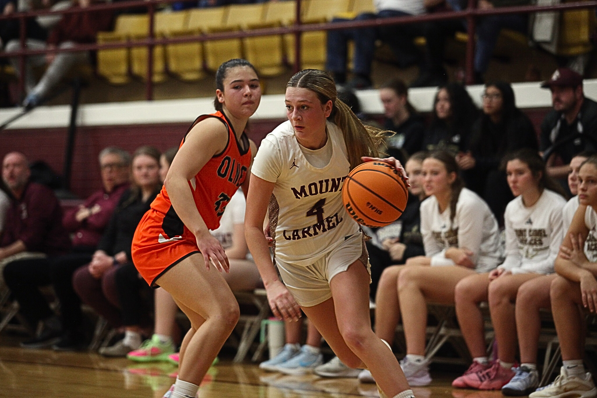 Riley Hershey (4) of Mt. Carmel drives on Olney during an LIC basketball game (Photo by Hometown Register).