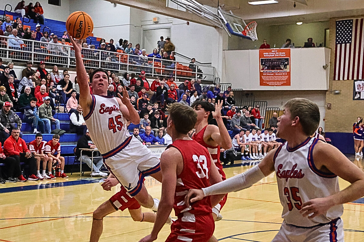 Drake Wolf (45) of Newton gets a shot off in the lane against Lawrenceville in an LIC game on Jan. 16 at Newton (Photo by Jasper County Daily News).