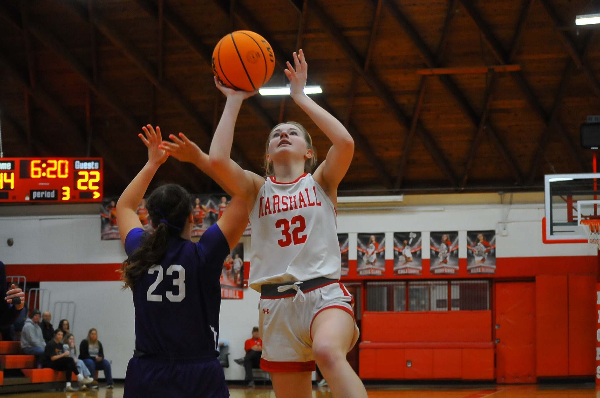Harper Richardson of Marshall (32) gets a shot off against Shelbyville's Alex Jokisch in an IHSA Regional tournament game on Saturday (Photo by Wabash News / Tom Lisella).