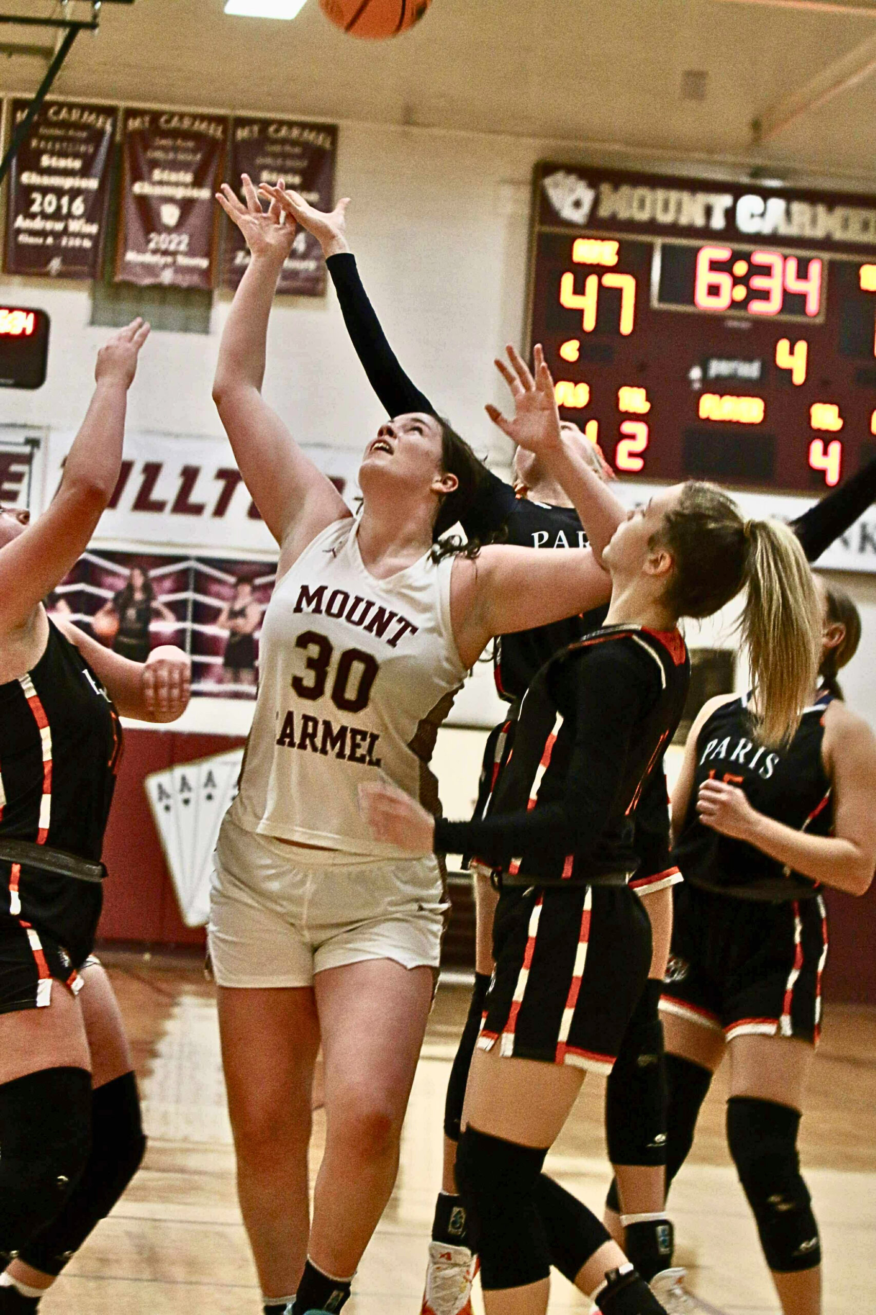 Macy Randall (30) of Mt. Carmel fights for a rebound against Paris in an LIC game on Monday night (Photo by Nichole Liddle Loudermilk).