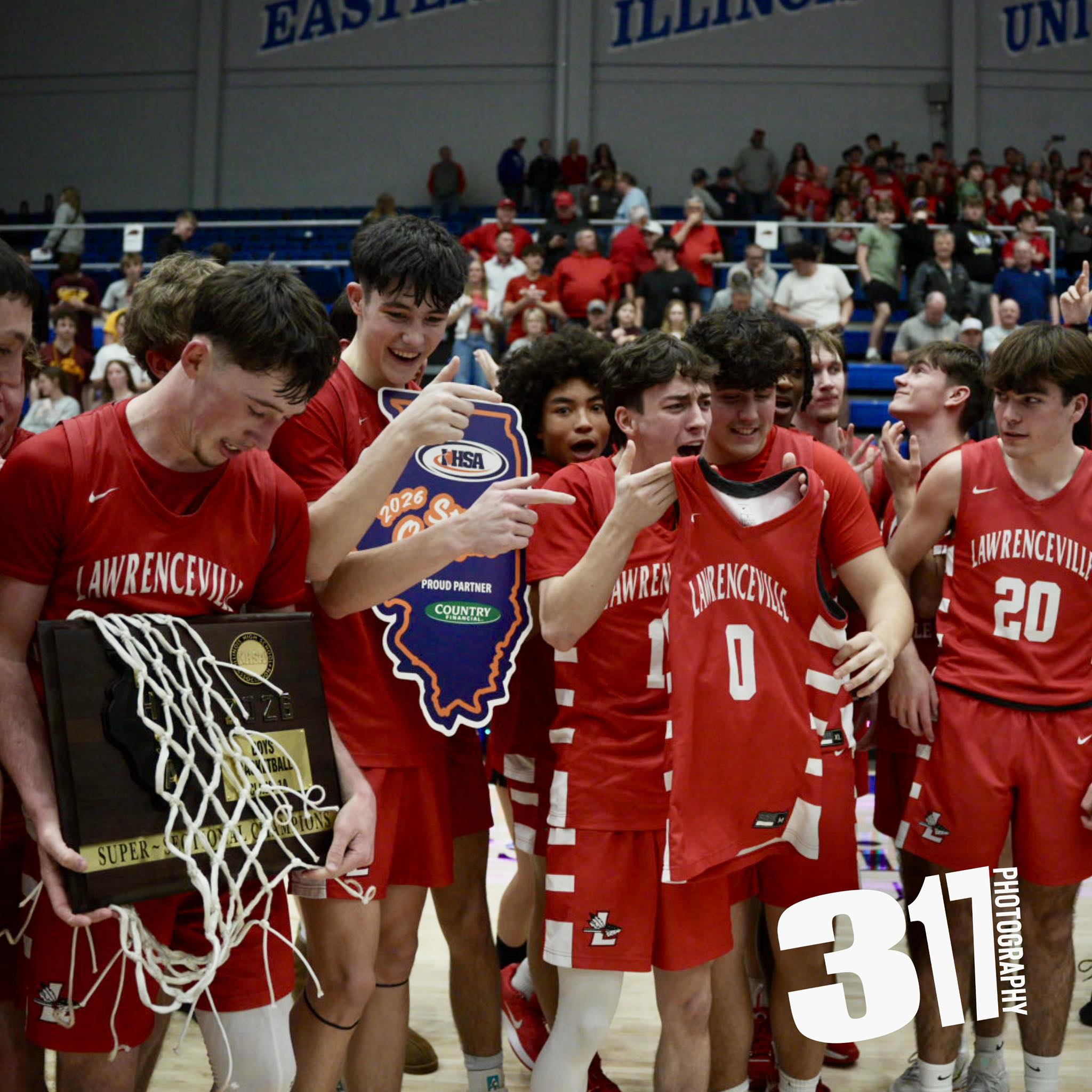 While celebrating the Class 1A Super Sectional championship, Lawrenceville players display the jersey worn by teammate Aiden Winningham, who is recovering at an Indianapolis hospital from injuries sustained in a car accident.
(Photo by 317 Sports Photography).